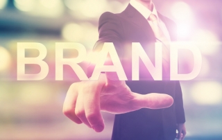 Businessman pointing at BRAND
